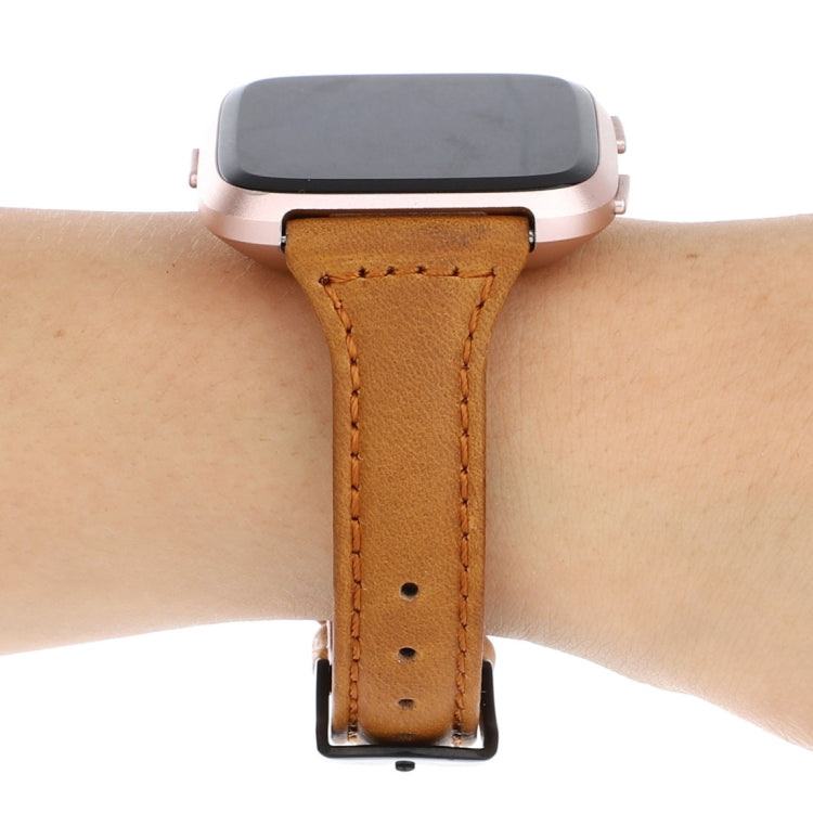 Light brown genuine leather Fitbit Versa strap with metal clasp on wrist