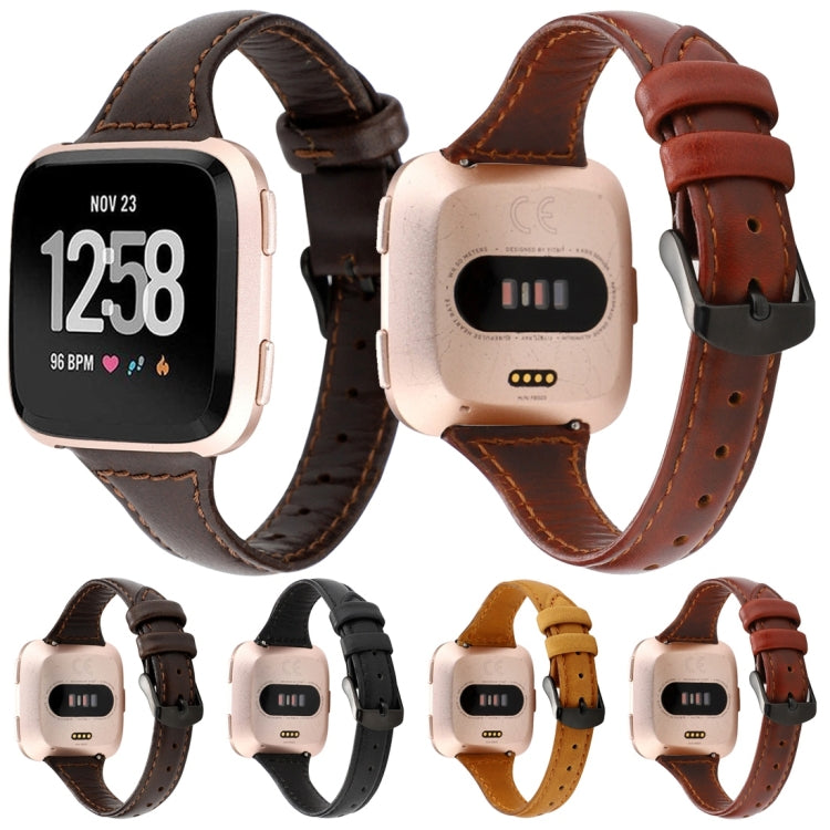 Multiple genuine leather Fitbit Versa straps in dark, black, tan, and red-brown colors