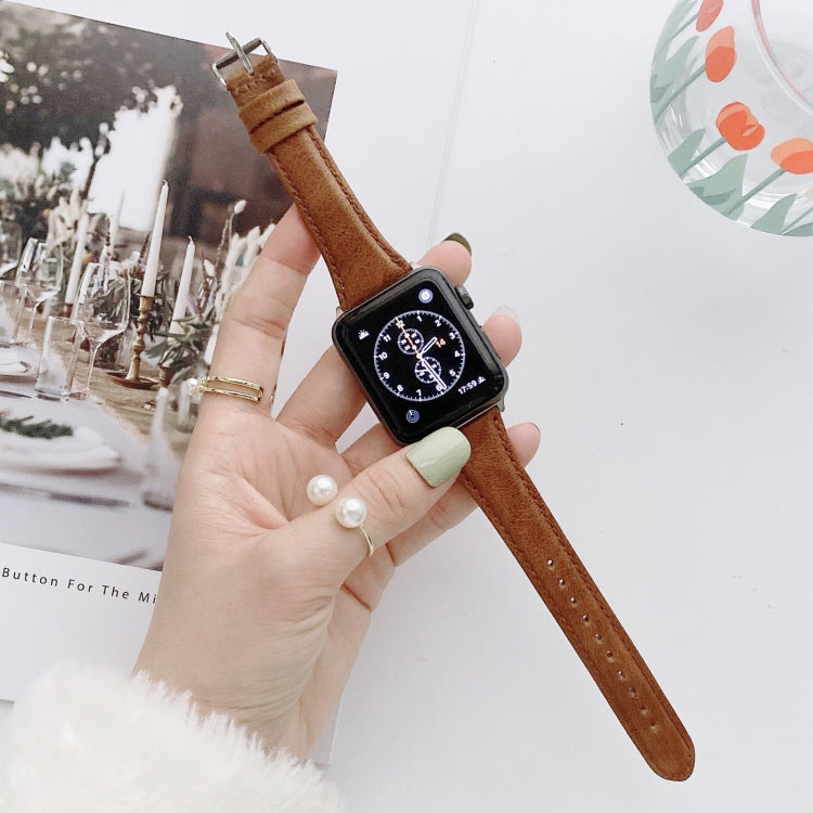 Brown leather watch band with metal buckle and stitched holes, double-sided strap for Apple Watch.