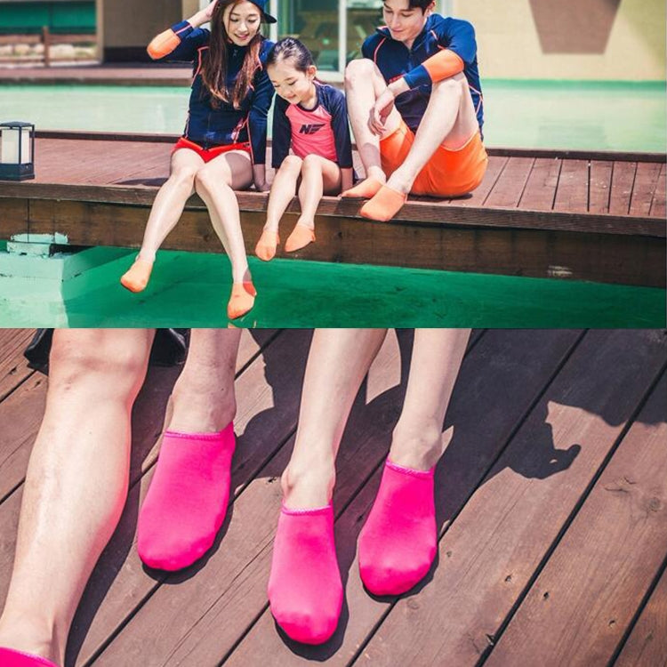 Pink slip-on water shoes on models seated by a pool
