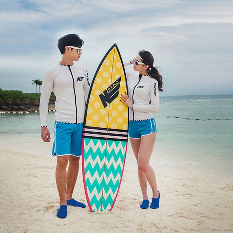 Blue slip-on water shoes on a couple with a surfboard
