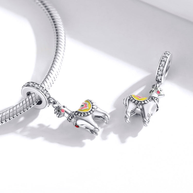 Silver snake-chain bracelet with dangling alpaca charms and CZ-studded details