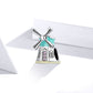 Windmill charm bead with teal enamel blades and arched door accents, pink CZ