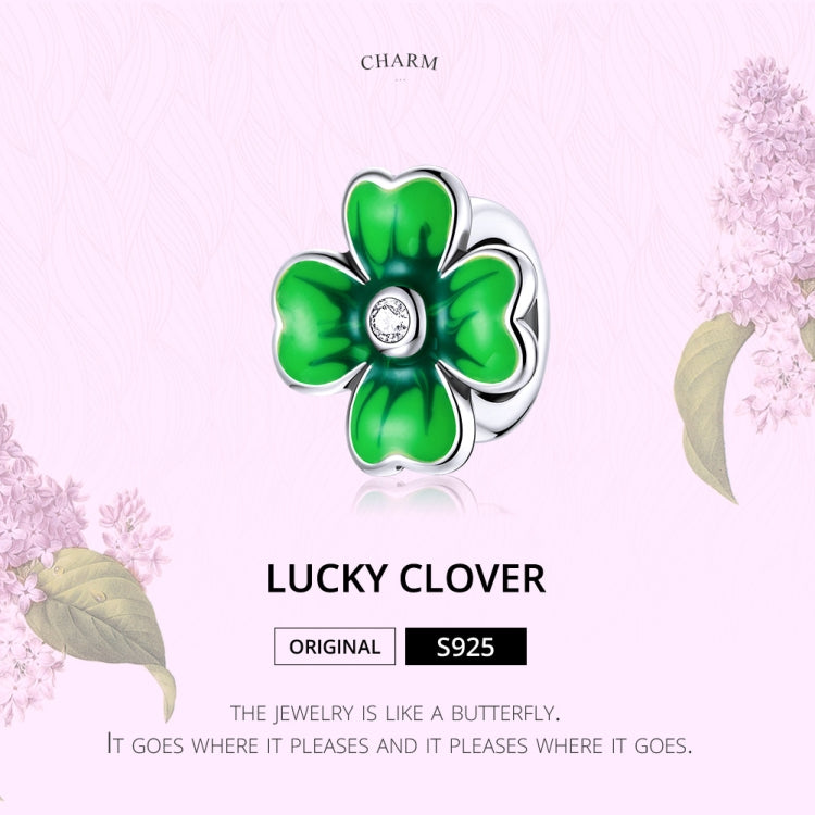 Green enamel clover charm bead with sparkling CZ center in silver scalloped ring
