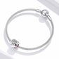 Silver chain bracelet with two engraved charm beads and pink heart stone accents