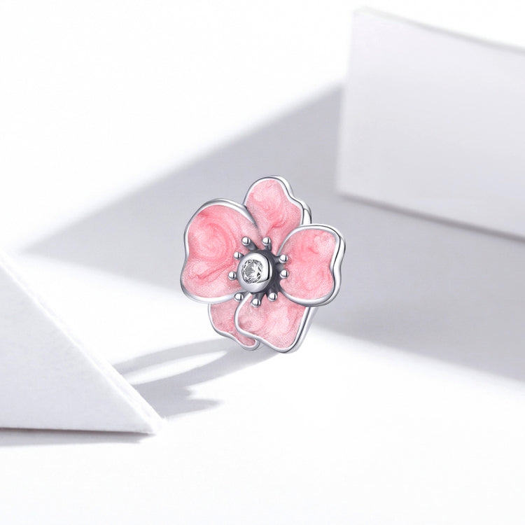 Pink enamel flower charm bead with silver frame and CZ center on ring