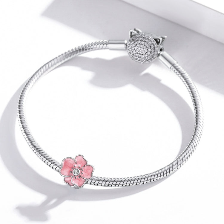 Silver snake bracelet with pink enamel flower charm and CZ cat-head charm