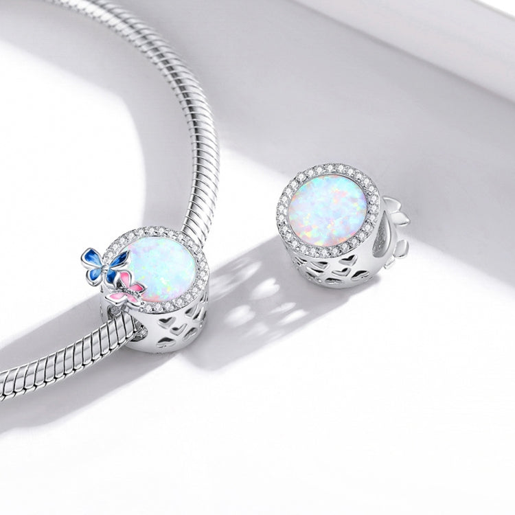 Sterling silver charm beads on bracelet chain, each with opal-like center and butterfly enamel