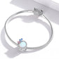 Sterling silver snake-chain bracelet with butterfly spring charm bead and opal-like center