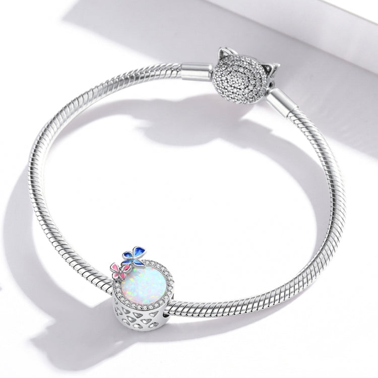 Sterling silver snake-chain bracelet with butterfly spring charm bead and opal-like center