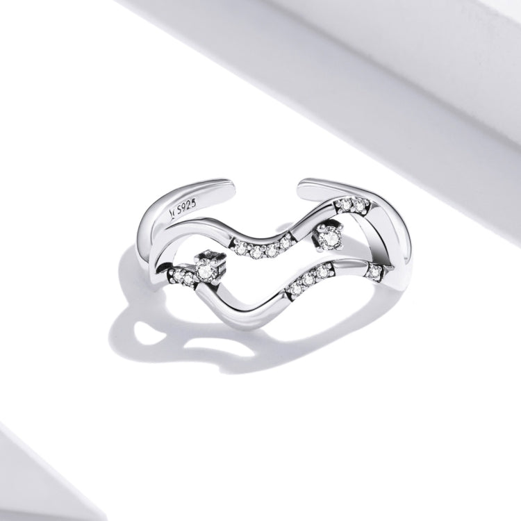 Sterling silver open band ring with swirling wave center and sparkling CZ stones