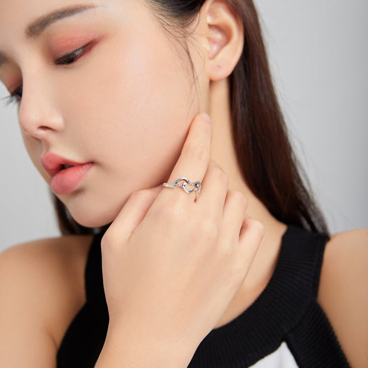 Sterling silver open ring with curved wave design and CZ stones on finger