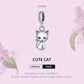 Sterling silver cat charm pendant with blue eyes, hanging on a twisted bail