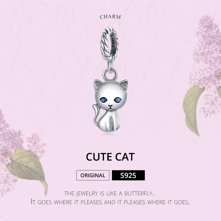 Sterling silver cat charm pendant with blue eyes, hanging on a twisted bail