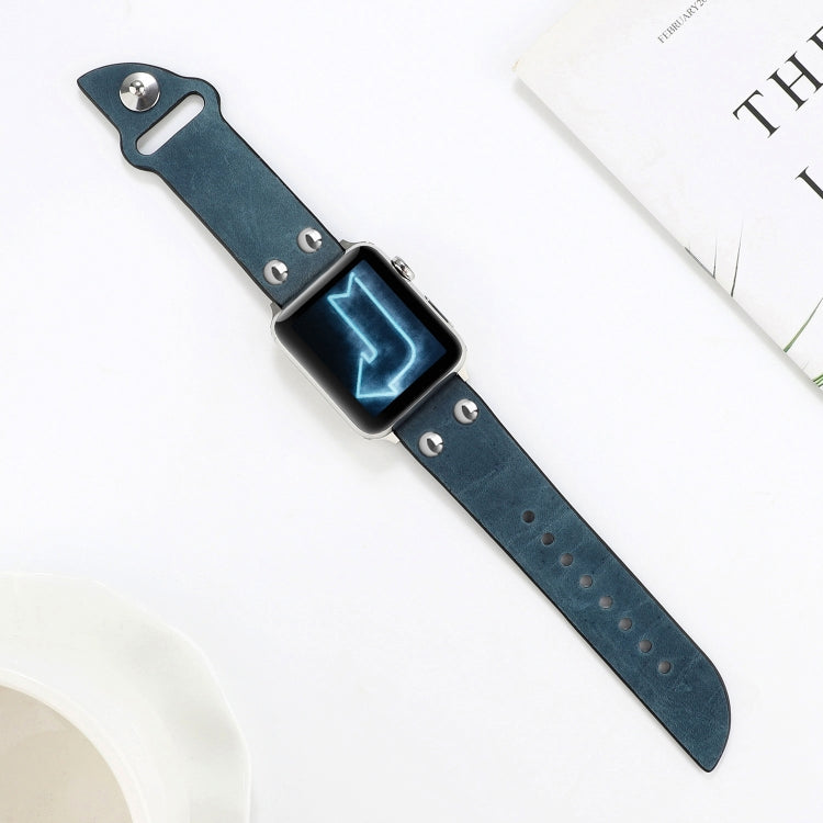Blue leather watch band laid flat with metal keeper and stud accents