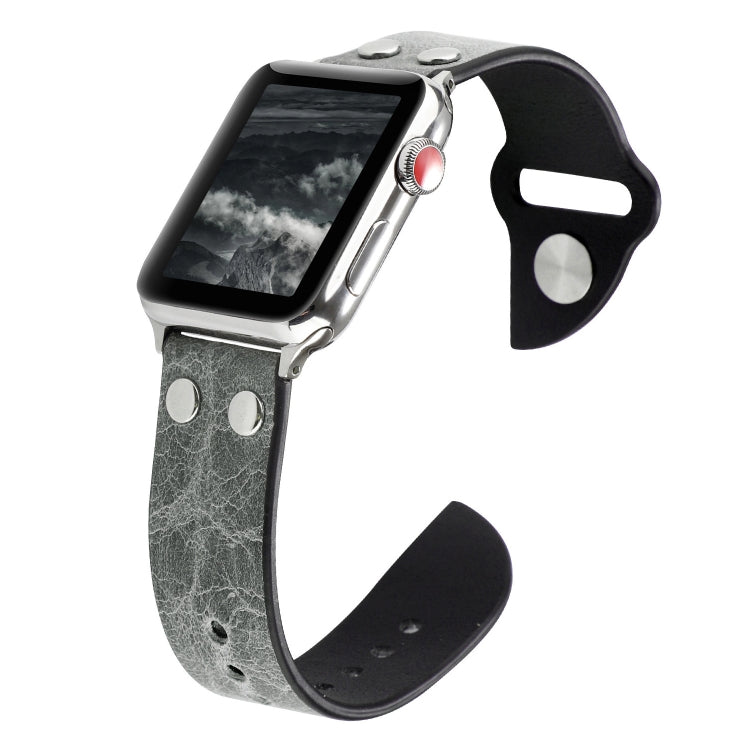 Grey leather watch band with metal buckle, stud accents, and punched holes