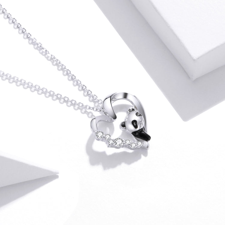 Heart panda charm necklace close-up with dangling crystal-like strands on a silver chain