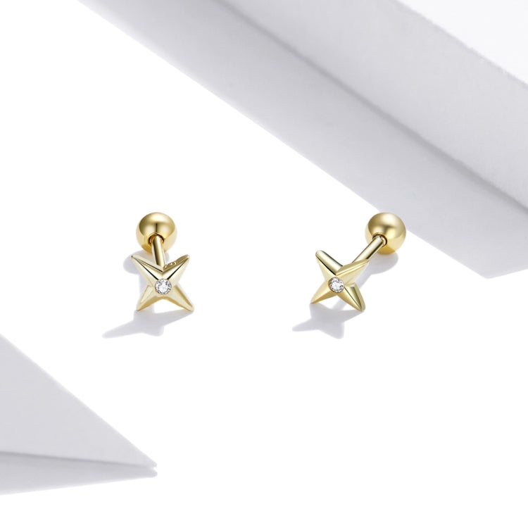 Pair of gold star stud earrings with small round CZ stone and ball post back.