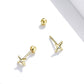Gold star stud earrings shown from side, with round CZ stone and post backing.