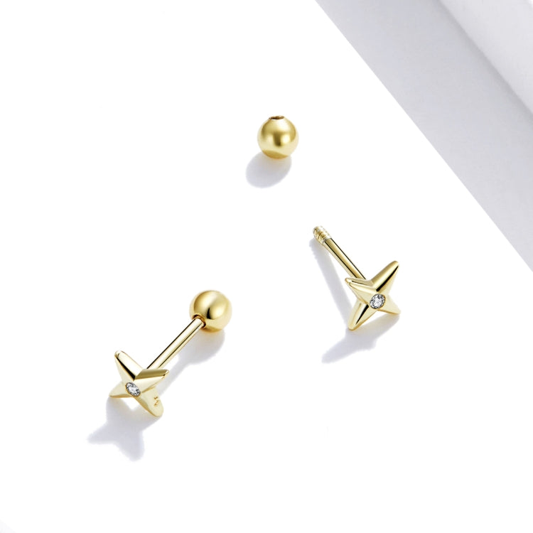 Gold star stud earrings shown from side, with round CZ stone and post backing.