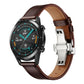Dark brown leather replacement watch strap with silver butterfly buckle, on smartwatch