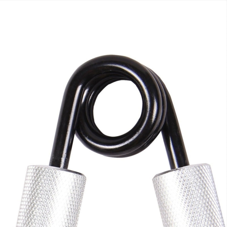 Wrist strength trainer close-up of black spring with silver mesh grip covers