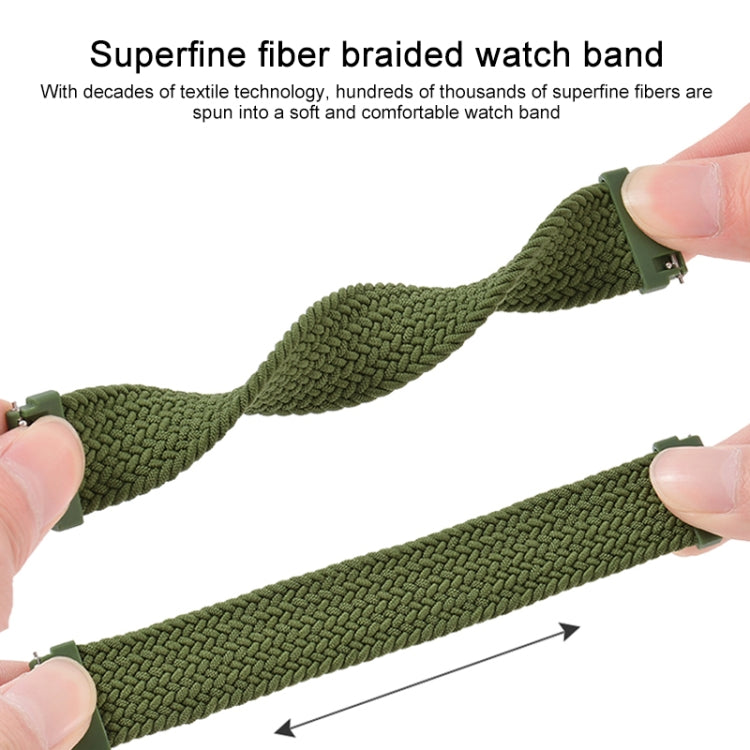 Olive green braided nylon watch strap with adjustable metal clasp, held by fingers