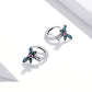 Sterling silver dragonfly hoop-style ear studs with blue wings, green details, and pink gem