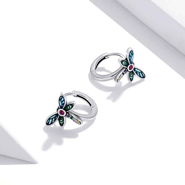 Sterling silver dragonfly hoop-style ear studs with blue wings, green details, and pink gem