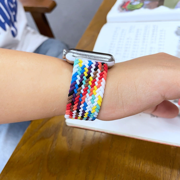 Rainbow braided watchband on wrist, multicolor loop strap with metal clasp