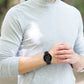 Black silicone watch strap on wrist with perforated band and metal clasp