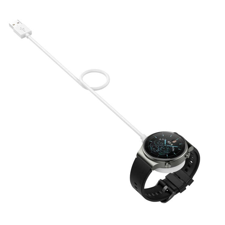 White magnetic smartwatch charger cable with round puck and charger base on watch