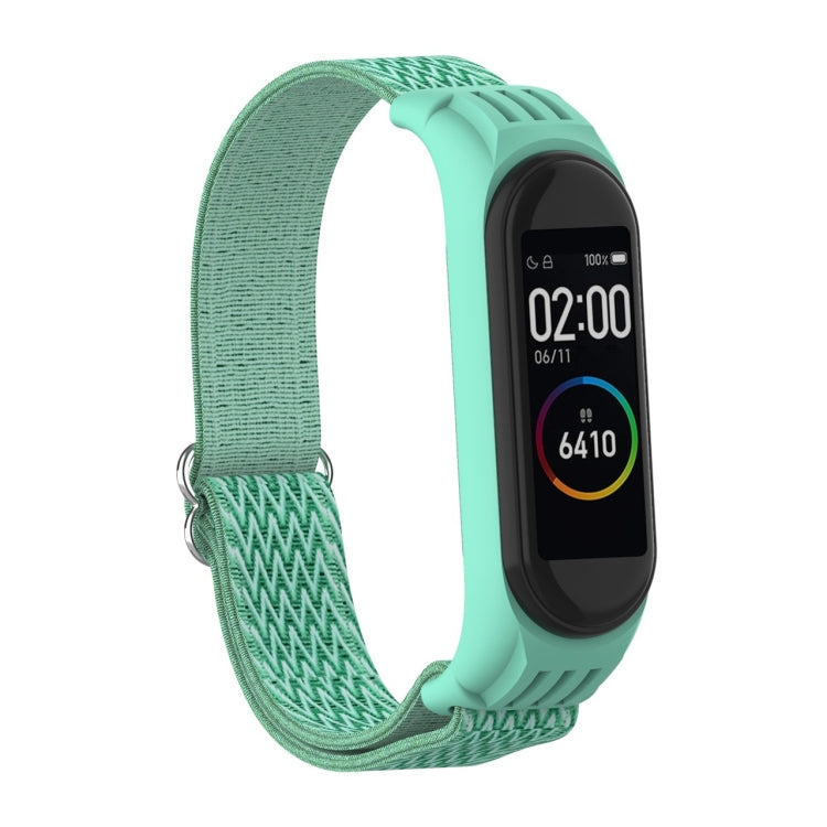 Sea green woven watch strap with zigzag pattern and metal buckle loop for fitness tracker.