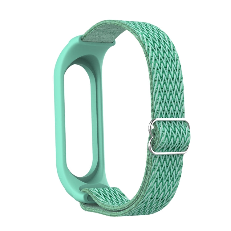 Sea green silicone watch frame with woven zigzag strap and round metal buckle clasp loop.