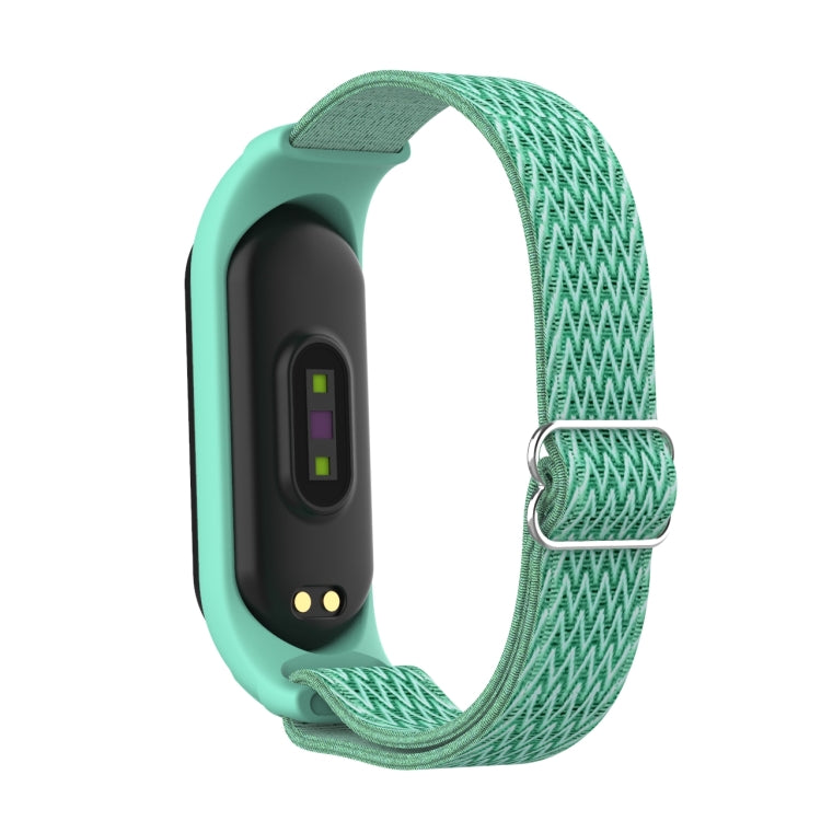 Sea green woven watch band with zigzag pattern and metal buckle clasp for activity tracker.