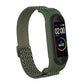 Olive green woven watch strap with zigzag pattern and metal buckle loop for fitness tracker.