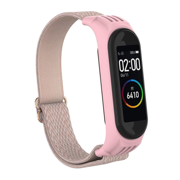 Pink replacement watch strap with woven zigzag texture and metal buckle loop for fitness tracker.