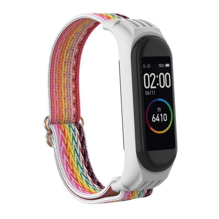 Colorful woven watch strap with white silicone frame and metal buckle clasp for fitness tracker.
