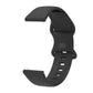 Matte black silicone watch strap with perforated holes and internal buckle, curved