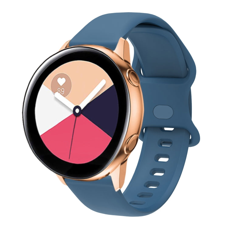 Blue silicone smartwatch band with perforated interior buckle, adjustable strap.