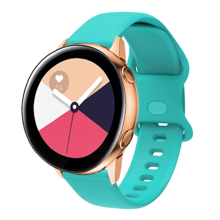 Teal silicone smartwatch band with perforated interior buckle, adjustable strap.
