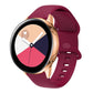 Wine red silicone smartwatch band with perforated interior buckle, adjustable strap.
