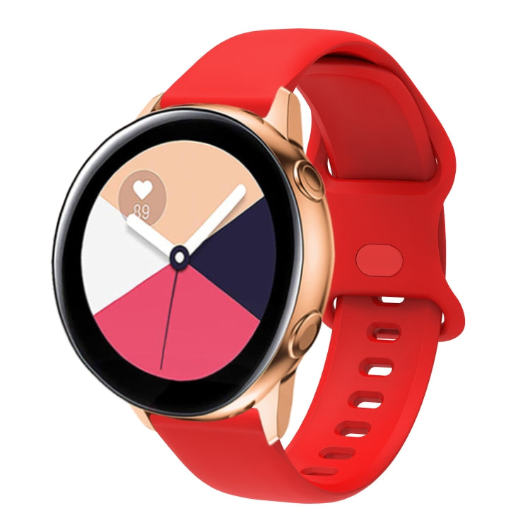 Red silicone smartwatch band with perforated interior buckle, adjustable strap.
