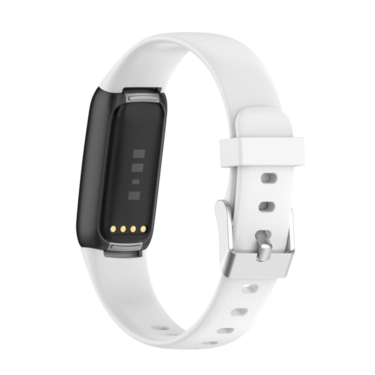 White silicone smartwatch band with buckle and perforations; dark fitness display shown.