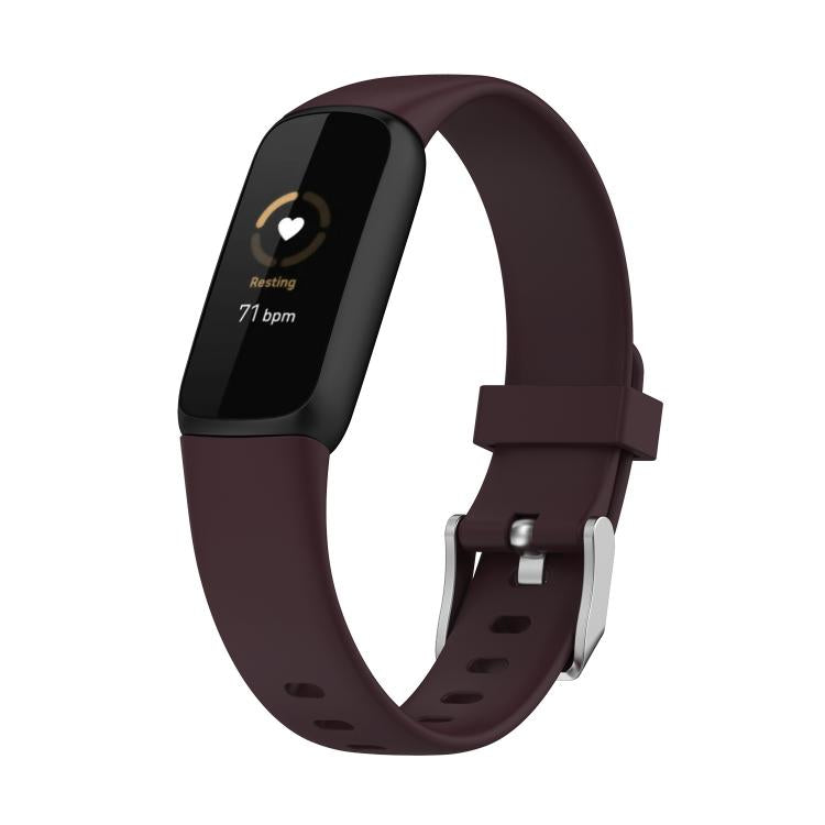 Dark purple silicone smartwatch band with buckle and perforations; dark fitness display shown.