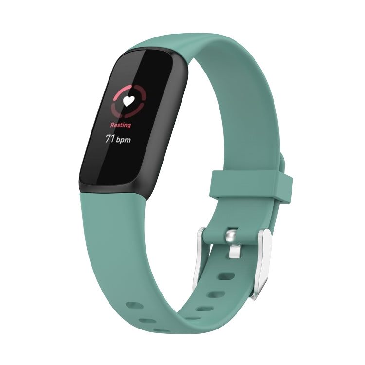 Pine Needle Green silicone smartwatch band with buckle and perforations; dark fitness display.