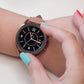 Rhombus-texture smartwatch bezel ring, rose gold finish on dark watch face with hand