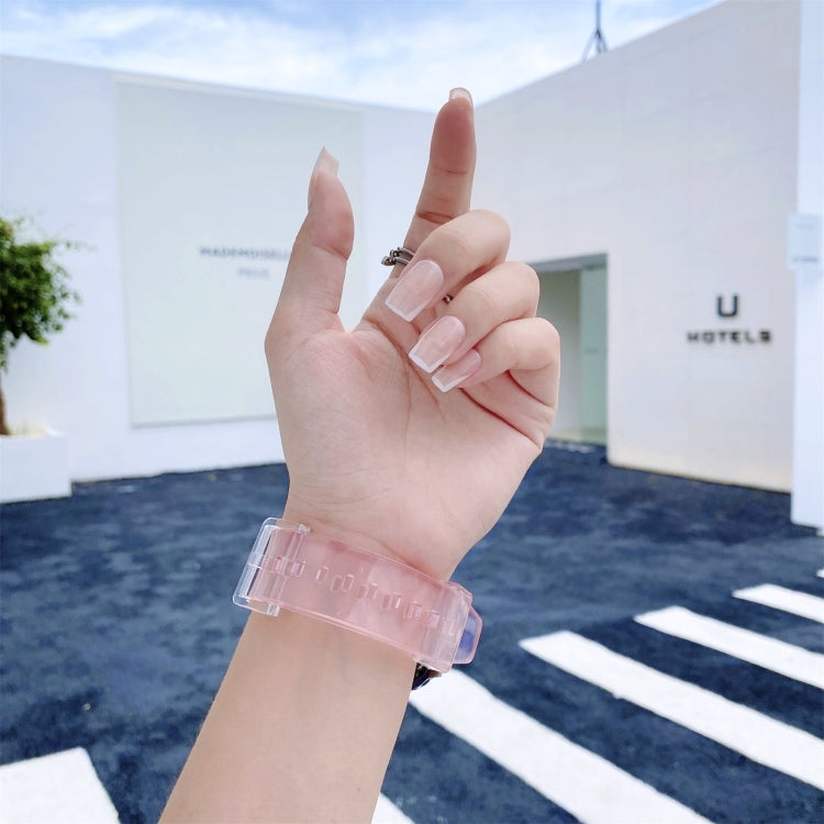 Pink translucent silicone watch strap with perforated holes and clear clasp, worn on hand