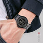 Black digital dual time LED watch on wrist with stainless steel link strap
