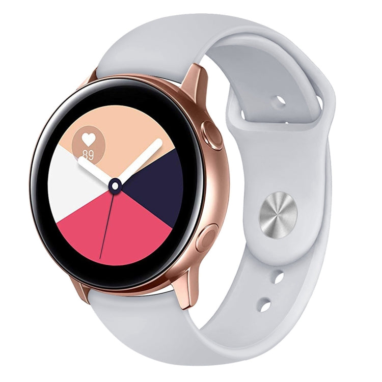 White silicone smartwatch wrist strap with pin holes and metal keeper on watch
